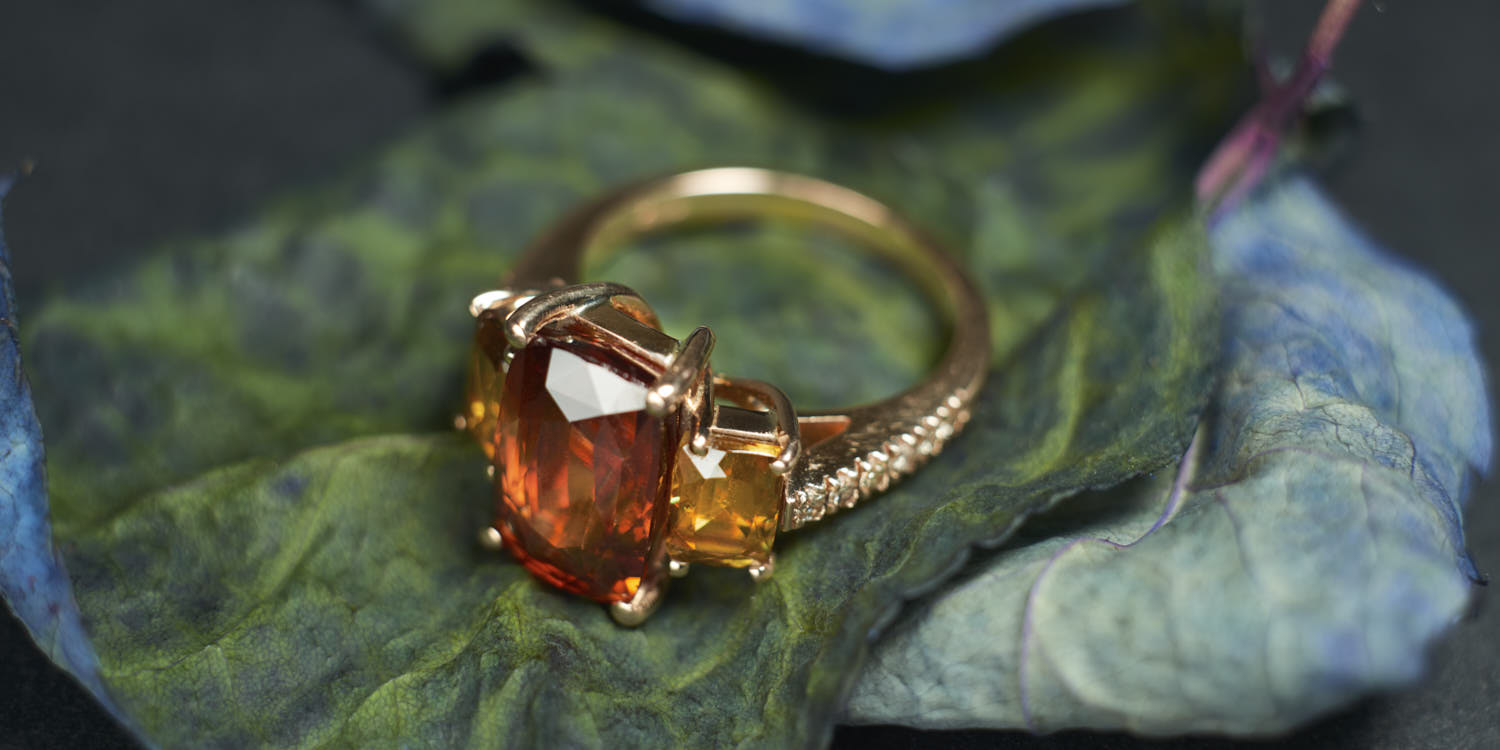 Red gold ring with natural red zircon and 2 natural titanite with light brown diamonds.